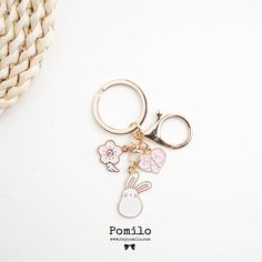 a keychain with a bunny and flowers on it