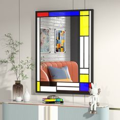 a living room scene with focus on the couch and colorful stained glass window above it