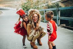 two children and an adult are posing for a photo with their costumed characters on