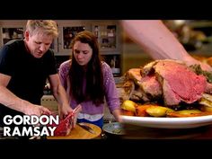 a man and woman are preparing food in the kitchen with a large roast beef on a platter