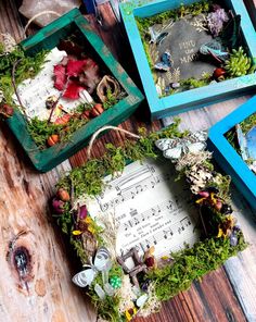 four frames are decorated with flowers and music notes on the table next to each other