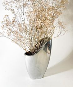 there is a silver vase with flowers in it