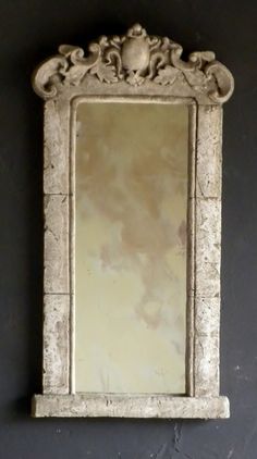 an old mirror is hanging on the wall