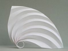 a white paper sculpture sitting on top of a table