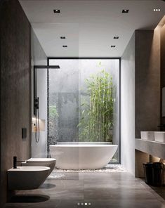 a bathroom with a large bathtub next to a sink and a bamboo plant on the wall