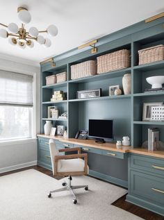 a home office with blue bookcases and white carpet