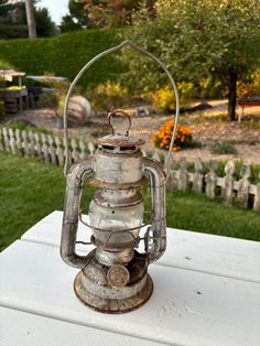 an old lantern sitting on top of a white table