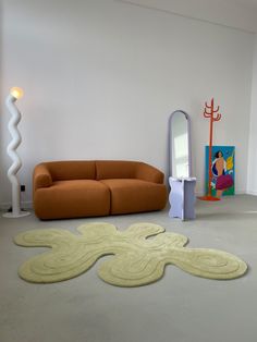 a living room with an orange couch and mirror on the wall next to a white floor