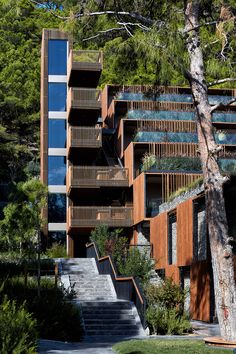 an apartment building with wooden balconies and stairs