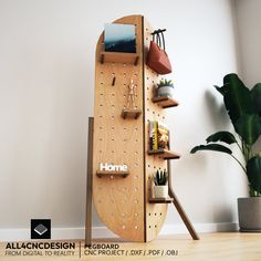 a wooden board with pegs on it next to a potted plant and bookshelf