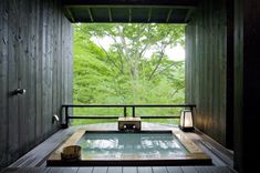 an outdoor jacuzzi tub in the middle of a wooden deck with lights on it