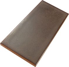 a close up of a brown tile on a white background