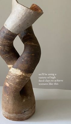 a wooden sculpture sitting on top of a white table