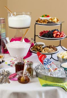 a table topped with different types of desserts and confection containers on top of it