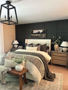 a bedroom with a large bed and two nightstands on either side of the bed