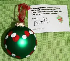 a green ornament with red and white dots on it next to a note