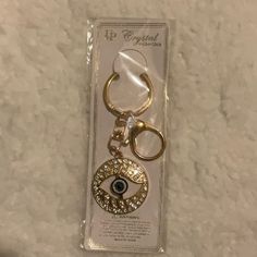 a keychain with an evil eye on it is in the package for sale