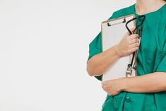 a woman in scrubs holding a clipboard with a stethoscope on it