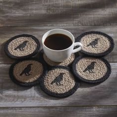 a cup of coffee sitting on top of four coasters