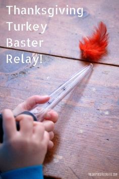 a child is holding a plastic knife with a red feather on it and the words thanksgiving turkey baster relay