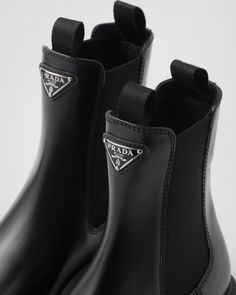 Upper with elasticized side gusset and pull tab Leather lining Enameled metal triangle logo 16 cm boot leg 55 mm rubber sole Lug tread Removable leather-covered insole Prada Monolith, Prada Boots, Prada Chelsea Boots, Prada Monolith Boots, Prada Black Boots, Prada Combat Boots, Lug Sole Boots, Triangle Logo, Black Boots Women