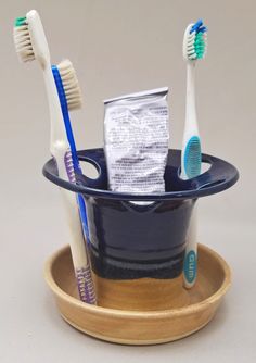 two toothbrushes are sitting in a cup