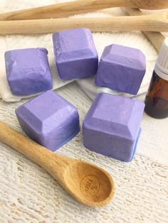 homemade shower melts are sitting on a towel next to a wooden spoon