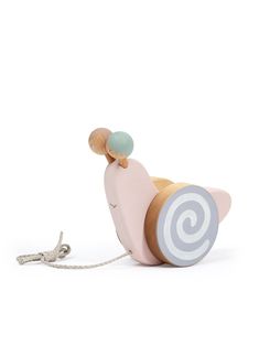 a wooden toy with a spiral design on the front and sides, sitting next to a string