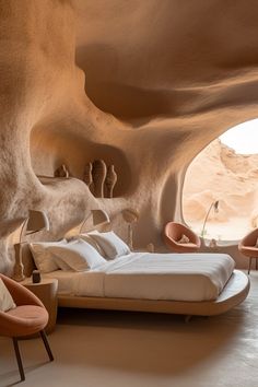 a large bed sitting inside of a bedroom next to a cave like room filled with furniture