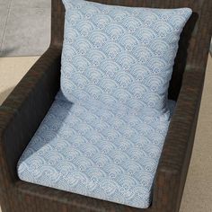 a brown chair with a blue pillow sitting on top of it