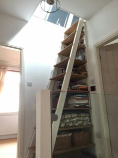 a stair case with shelves and baskets under it