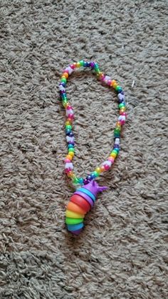 a multicolored beaded necklace laying on the floor