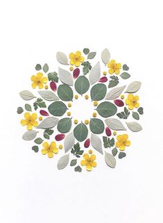 a white background with yellow flowers and green leaves in the shape of a flower arrangement