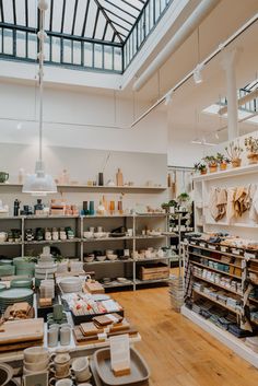 the inside of a pottery shop with shelves full of pots, bowls and other items