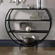 a shelf with some books on top of it and a bowl in front of it