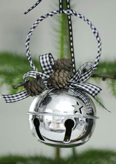 a christmas ornament hanging from a tree with a pine cone and ribbon on it