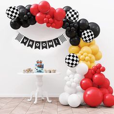 mickey mouse balloon arch with black and white checkerboard balloons for a birthday party