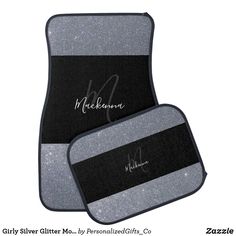 two black and gray mats with silver glitters on them, one has the name michael