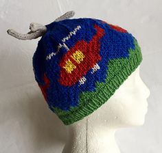 a white mannequin head wearing a multicolored knitted beanie hat