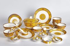 a collection of yellow and white dinnerware