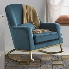 a blue rocking chair sitting on top of a rug