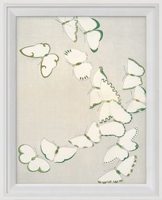 a white frame with green and white butterflies in the shape of hearts on it's side