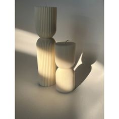 three white vases sitting next to each other