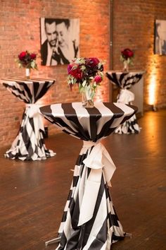 black and white striped table cloths with roses in vases on the end tables