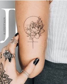 a woman's arm with a flower tattoo on the left side of her arm