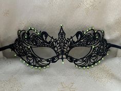 Black Lace Masquerade Mask with Glass Peridot Green Diamantes Black/Light Green Double 6mm Satin Ribbons each side (Approx 1m) to secure your Mask Comfortable and Soft to wear all Evening Complete with Silver or Black Organza Carry Bag Measures: 8.5" by 3" Approx and will fit most Adults Beautiful Mask for any Special Occasion Masquerade Balls, Charity Event Balls, Hunt Balls New Year's Eve Party Christmas Party Proms Weddings Halloween Parties Black Masquerade, Halloween Weddings, Black Masquerade Mask, Lace Masquerade Masks, Mask Ball, Satin Noir, Peridot Green, Masks Masquerade, Charity Event