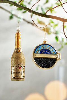 two wine bottle ornaments hanging from a tree