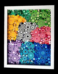 an art work made out of colorful circles and dots in white frame on black background