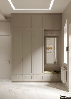 an empty room with white walls and cabinets