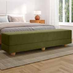 a large bed sitting on top of a wooden floor